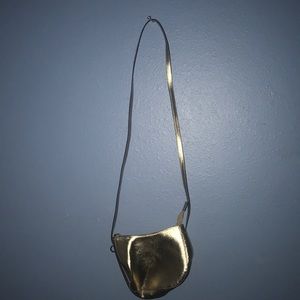 gold cross body purse .